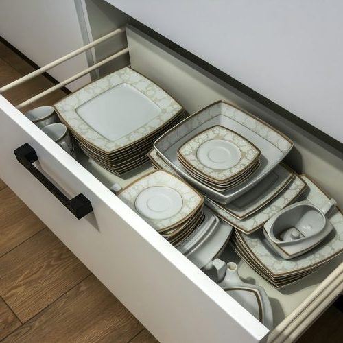 Open kitchen drawer with plates inside, a smart solution for kitchen storage and organizing