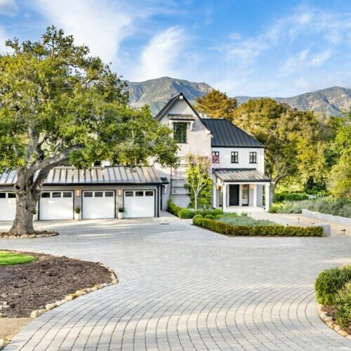 this home has brick driveways and driveways in front of it