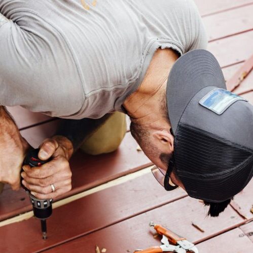 Man repairing wooden decking